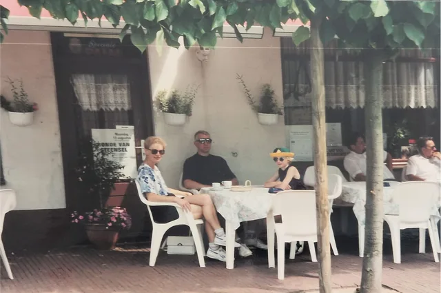 The family sitting at an outdoor café table on holiday in the Netherlands.
