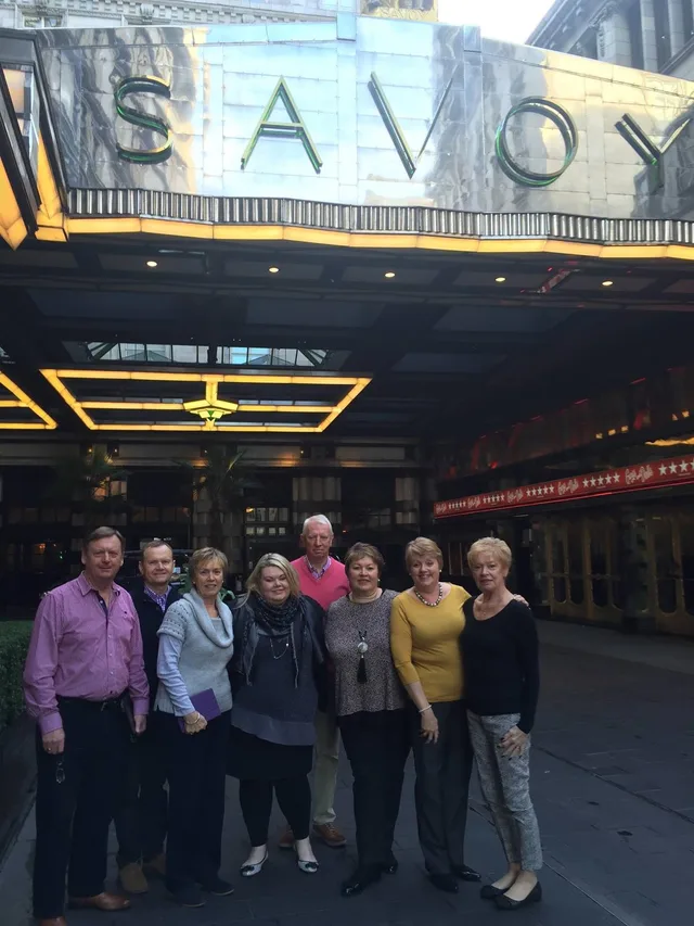 Iain, Pam and family gathered beneath the Savoy Theatre sign in London.